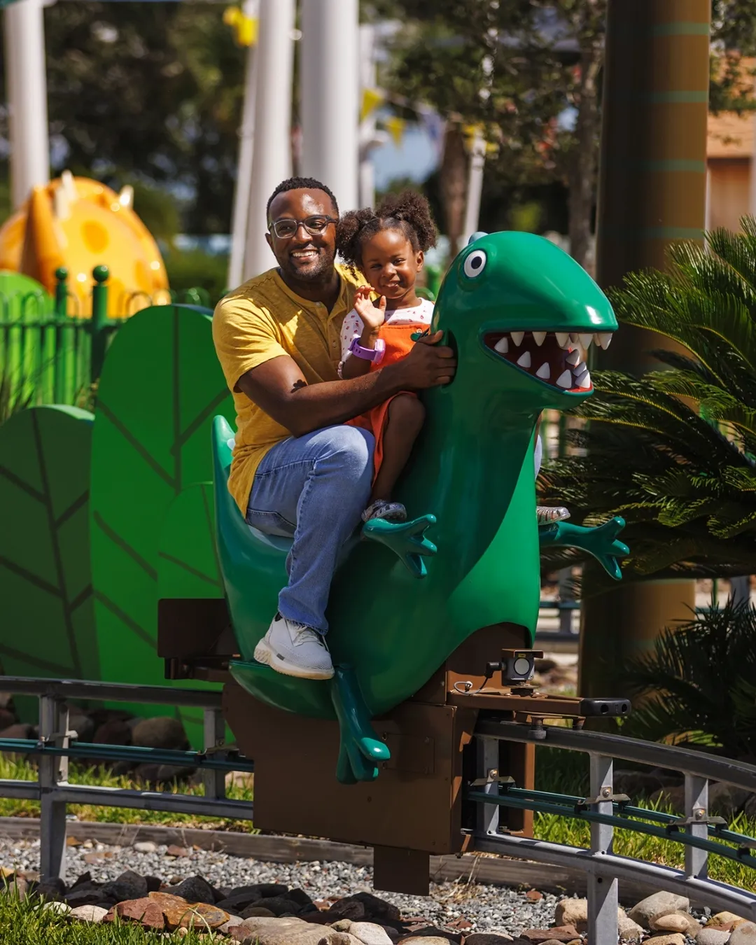 Dad and child enjoying the Dinosaur Ride at PEPPA PIG Theme Park Florida 